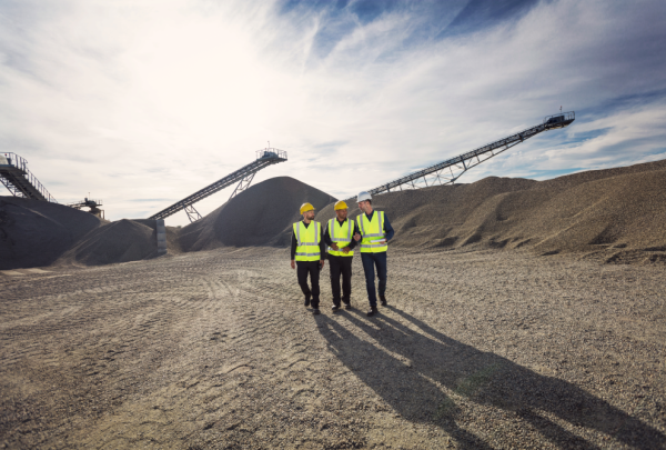 three mining workers on a mine site