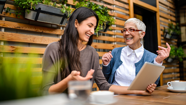 Two ladies talking over coffee.