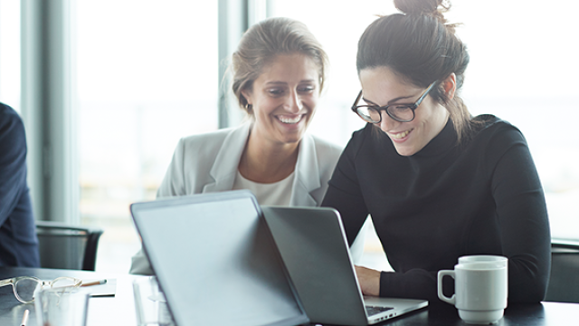 Woman on laptop searching internet.