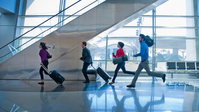 business travellers rushing through the airport