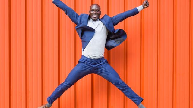 Man jumping for joy at a new offer from Accor Hotels with Corporate Traveller. Fast Track to Silver, Gold or Platinum benefits