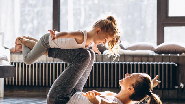 Mother and daughter yoga at home