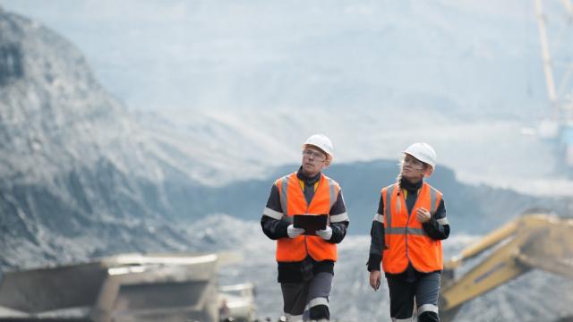 Two men inspecting mining site