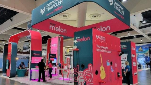 convention booth with bright pink and teal accents