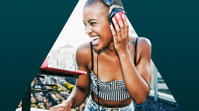 Women DJ with a black and white strip top