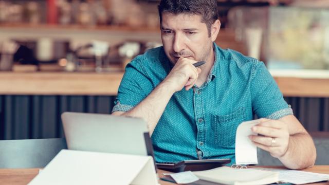 Man checking expense receipts with ipad