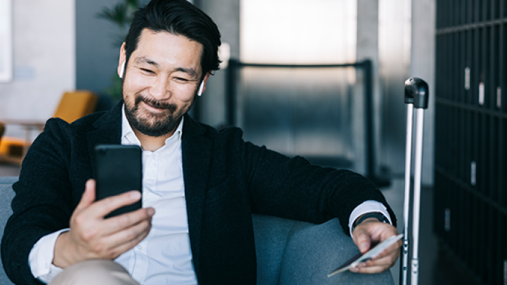 Man sitting on lounge looking at phone.