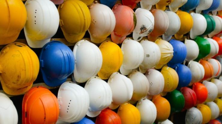 Old and worn colorful construction helmets