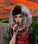 drag queen speaking into a microphone