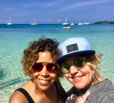 two women on a beautiful beach in Jamaica with turquoise water on a sunny day