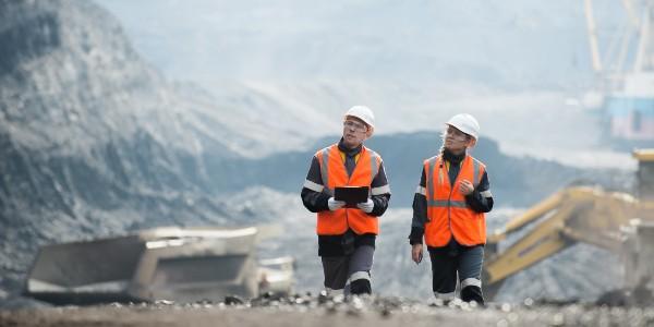 Two men inspecting mining site