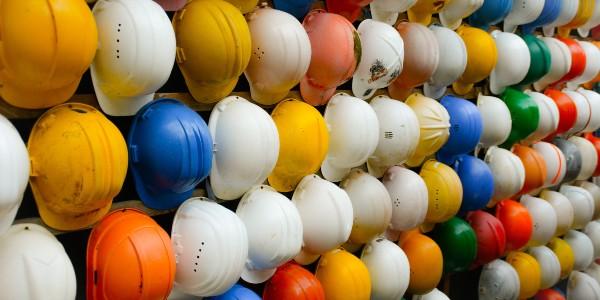 Old and worn colorful construction helmets