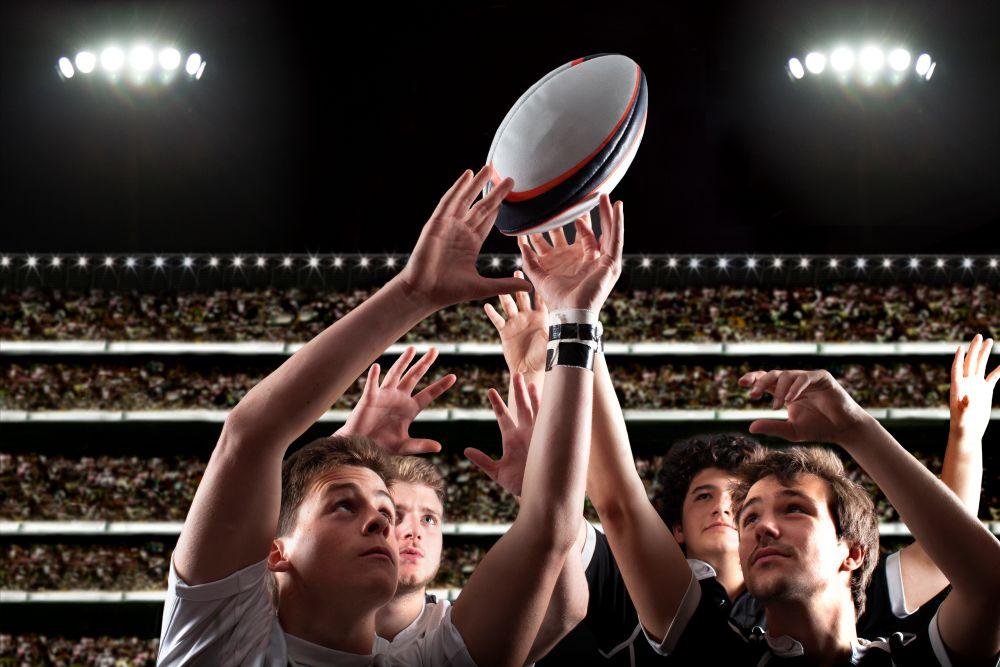Rugby game with players trying to reach the ball