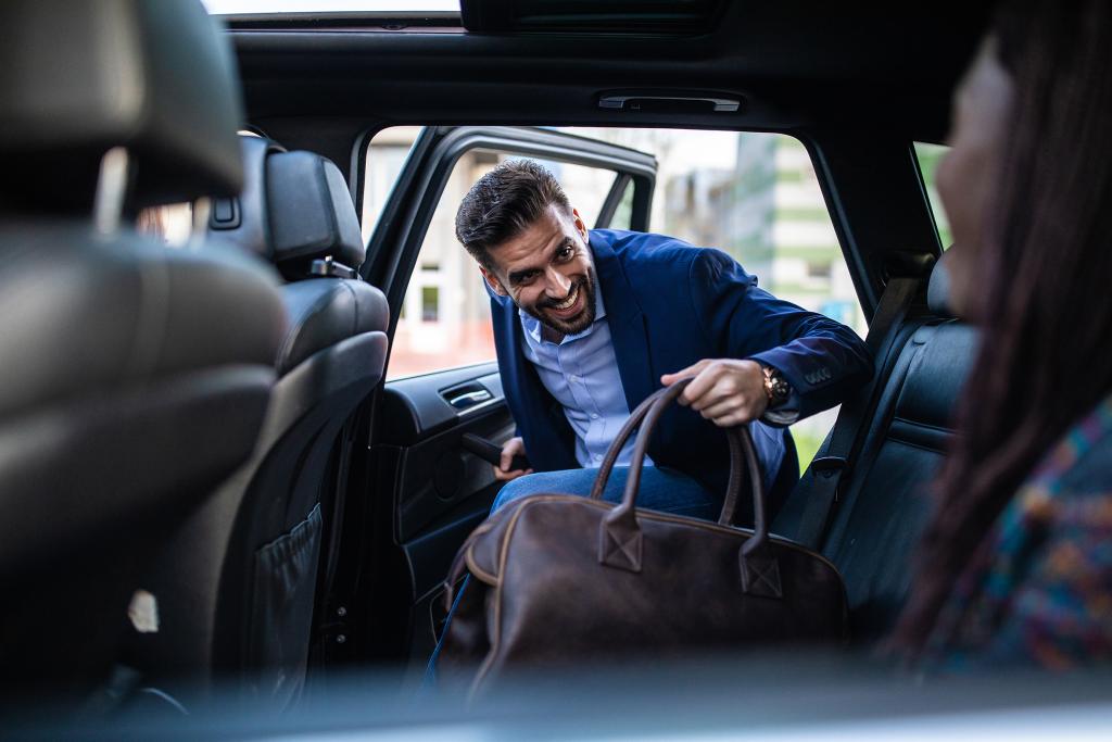 A businessman entering the car