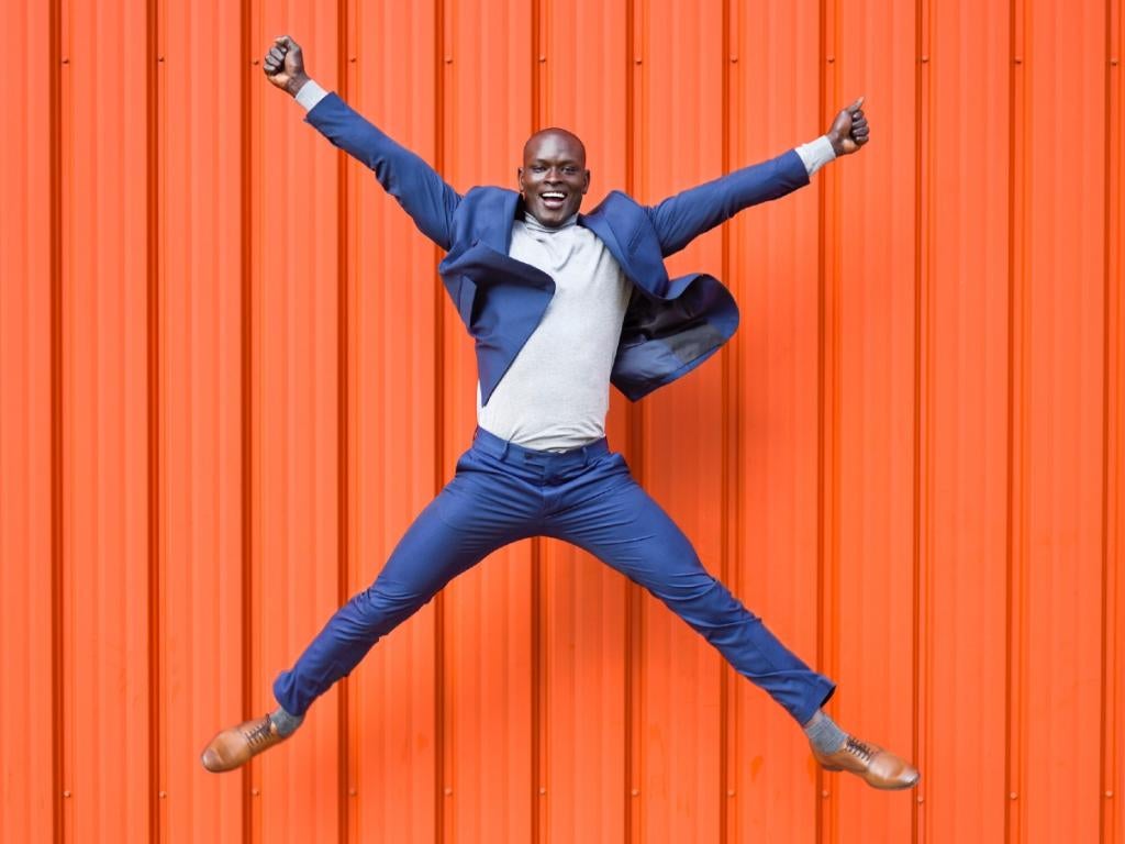 Man jumping for joy at a new offer from Accor Hotels with Corporate Traveller. Fast Track to Silver, Gold or Platinum benefits