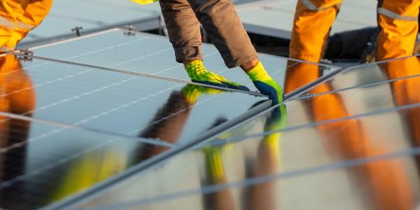 Workers fixing solar panels