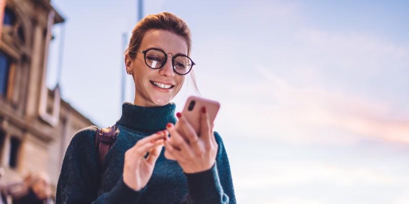 Young woman on her phone reading updates