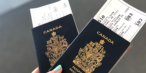 two canadian passports with boarding passes tucked inside