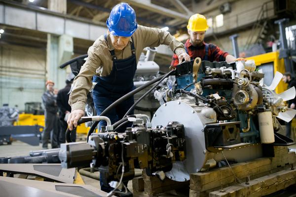 two people working at a manufacturing plant