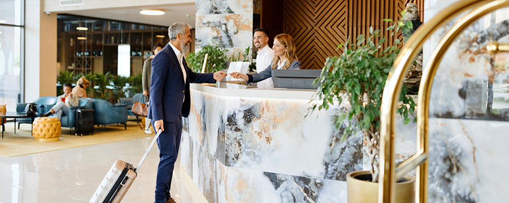 An older man standing at the hotel reception representing meaningful ways to engage with Youth Day. 