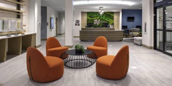 Hotel lobby from Even Hotels with orange relaxed chairs and modern design