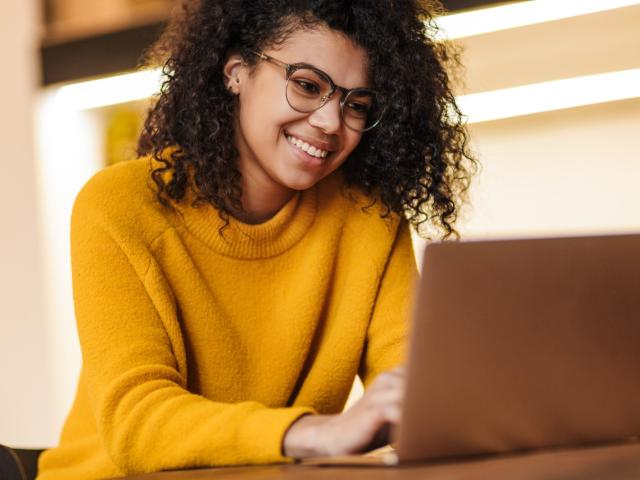 Woman creating her travel policy on her laptop